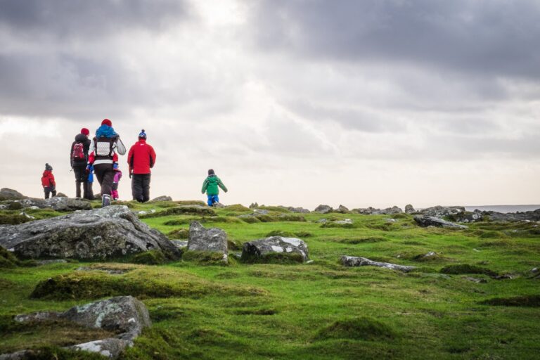 Families walks across Dartmoor, Plymouth, on a cold, cloudy day